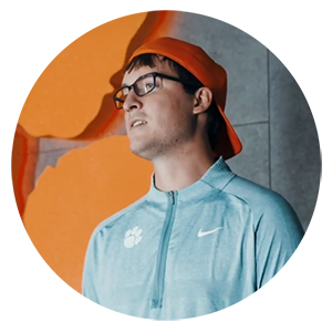 Alex Bina giving a presentation on football and physics in the Clemson Athletics facility