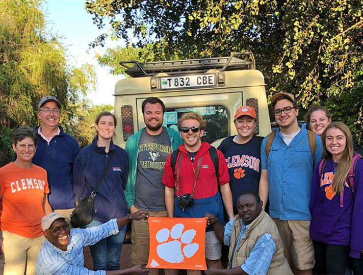 Study Abroad group with orange tiger rag flag. 