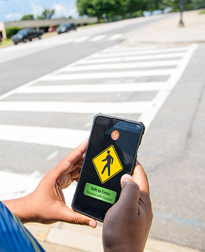 Phone alerting that it is safe to walk across intersection. 