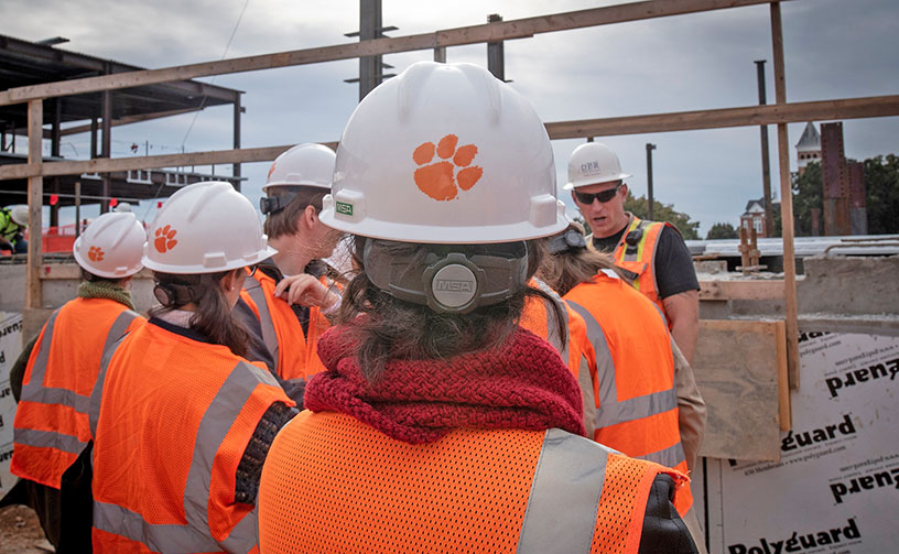 Students wearing had hats with tiger paws on them.