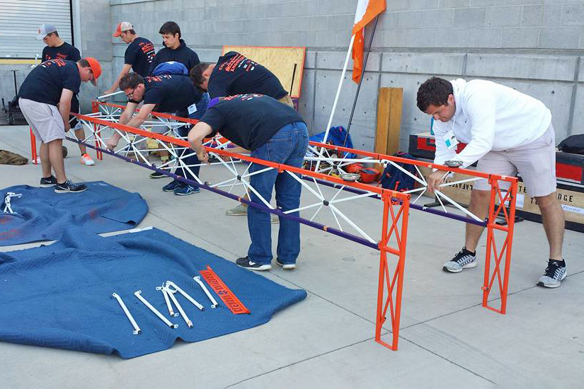 Students constructing steel bridge.