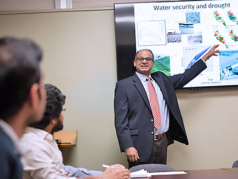 Mishra in class in front of his students.