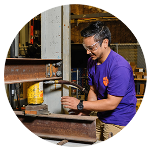 Basu inside Clemson’s structures lab, studying how and when masonry beams bend and break.