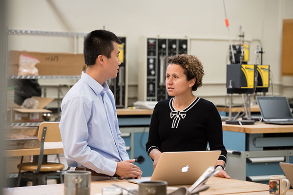 Sandra Eksioglu and Qiushi Chen work in a lab at Clemson University