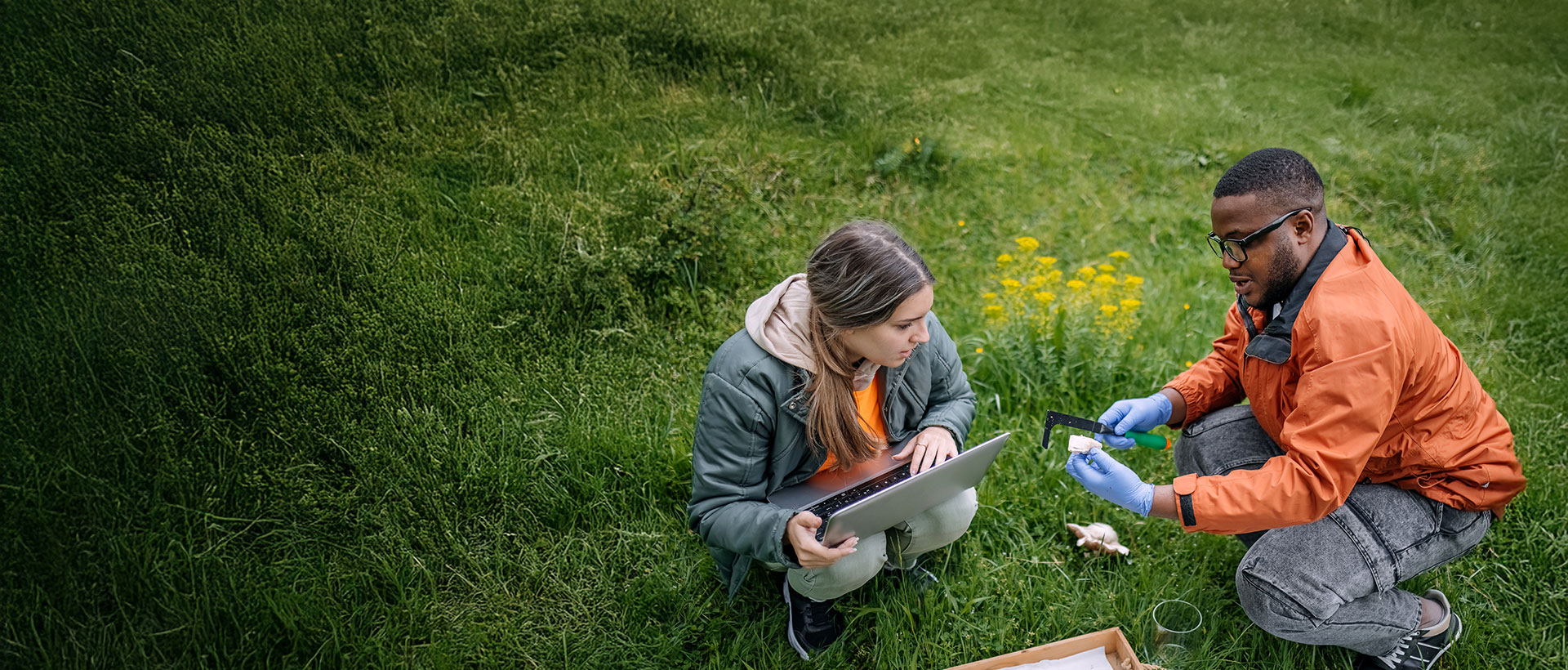 Student receiving mentoring while out in the field