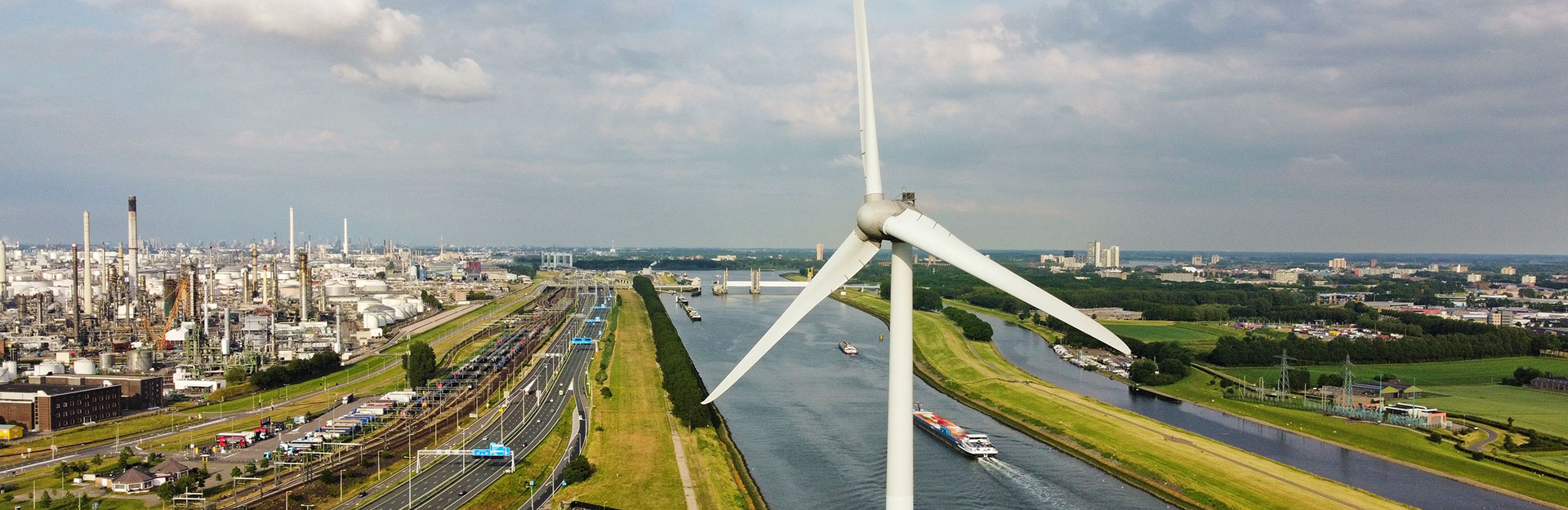 A surveyor with wind farm in background