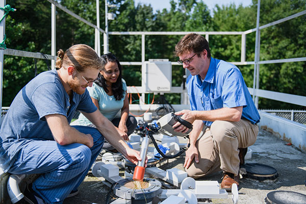 School researchers working on a test bed that was developed for their research.