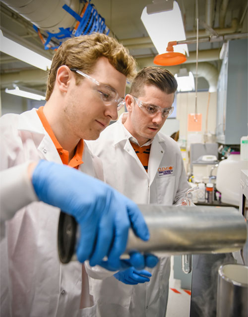 Eric Davis with student in lab