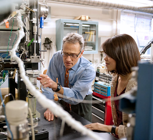 Thies with female student in lab.