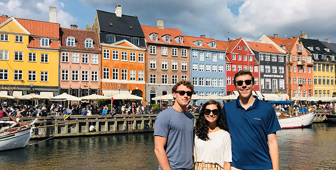 Students in front of colorful row houses in Denmark.