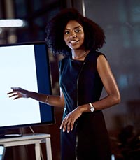 Female in front of screen presenting