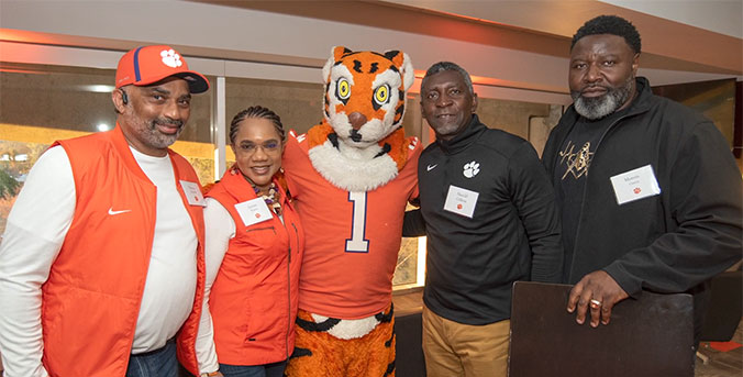 Harold Gillens posing with Tiger mascot and others