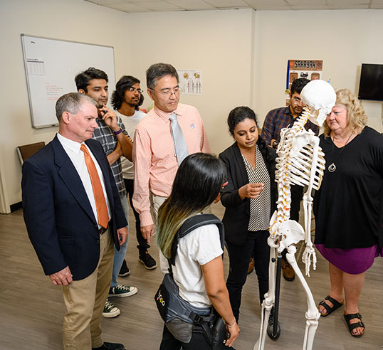 Graduate students and faculty discussing ergonomics at CUICAR.