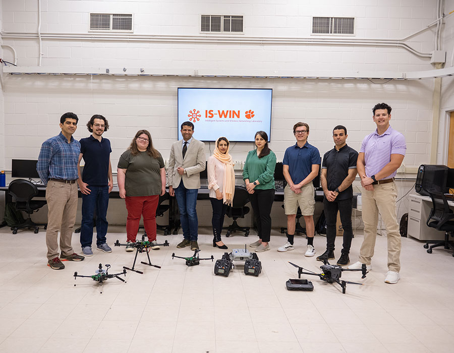 Group gathered around drone equipment in lab space