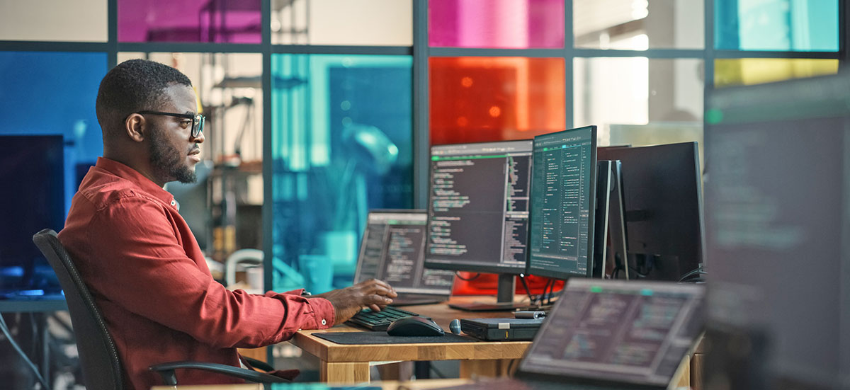 Man sitting at desk taking a class on his computer.