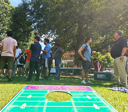 Graduate students gathered at Trustees Park with outdoor games.