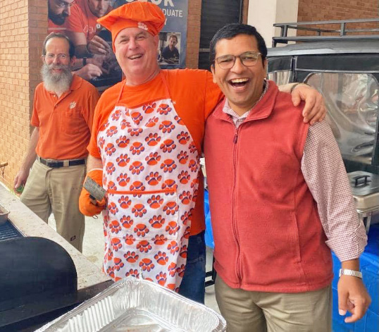 Grilling gathering outside of Riggs Hall