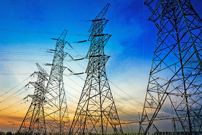 Looking up at electric towers