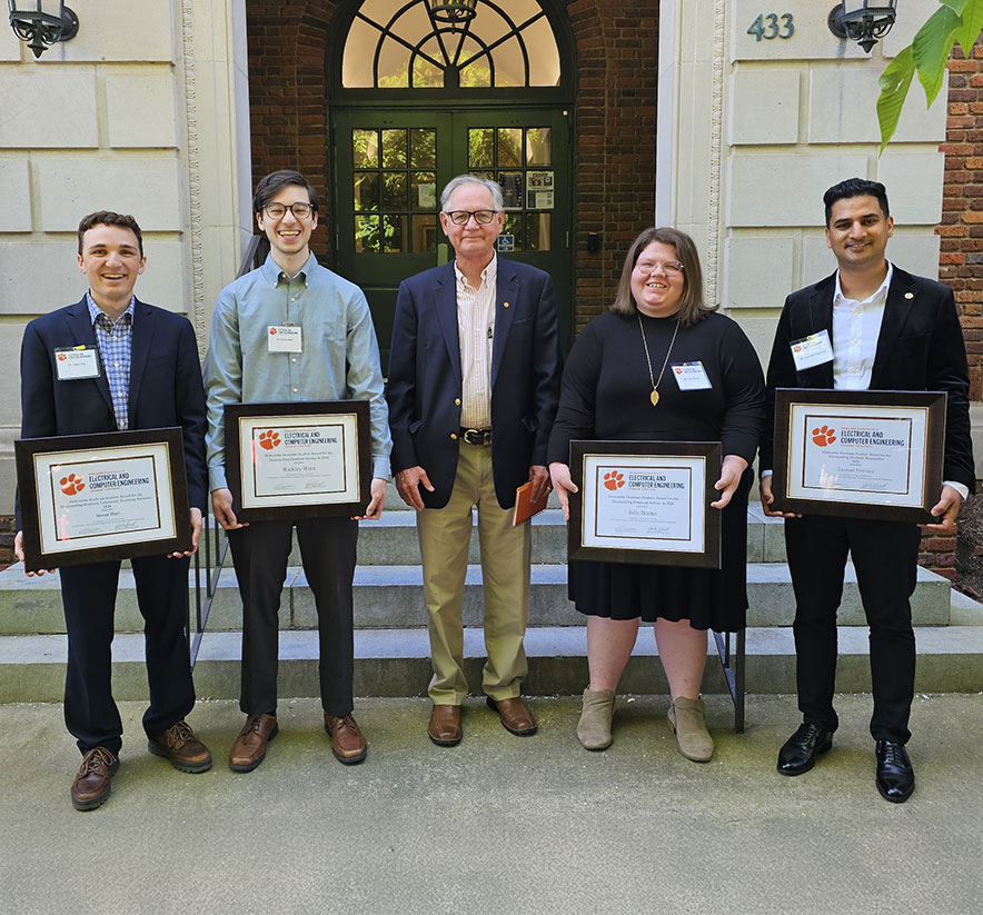 Graduate student award winners accepting plaques