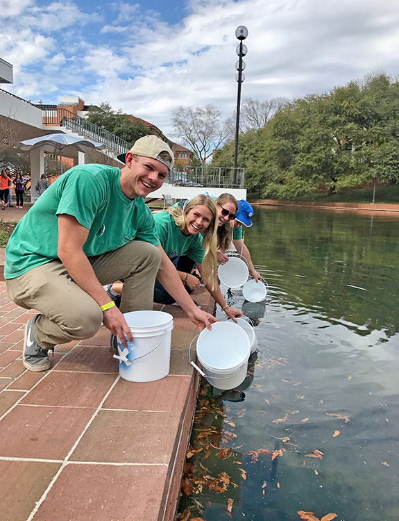 Students at Cooper Library pond testing water.