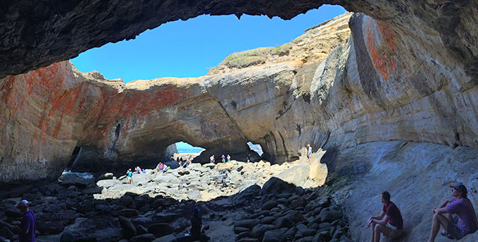 Group of people in large cave in Oregon.