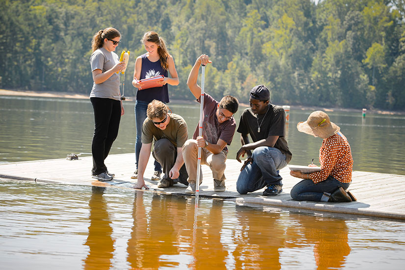 Students on floating dock performing tests.