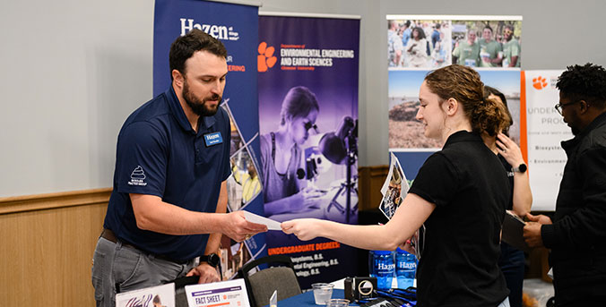 Student talking with industry member at career fair
