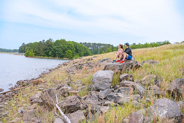 Michael Smith sitting with friend on Clemson water dikes