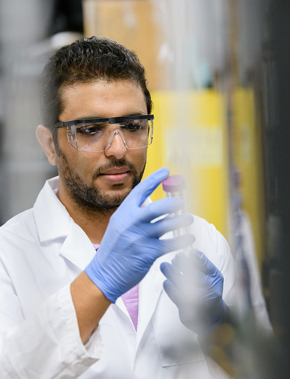 Male student in lab performing tests.