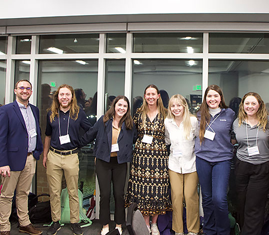 Group of students with event name tag lanyards on