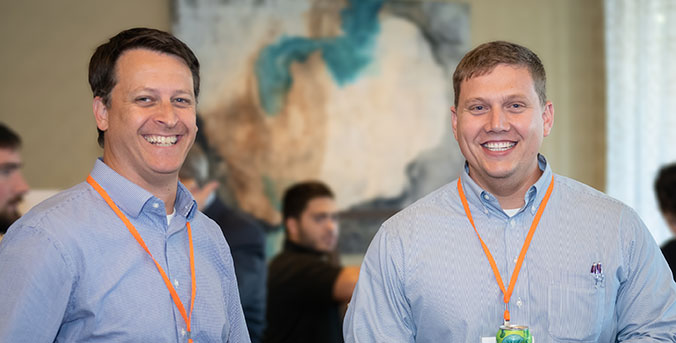 Two participants with lanyards at Madren Center.