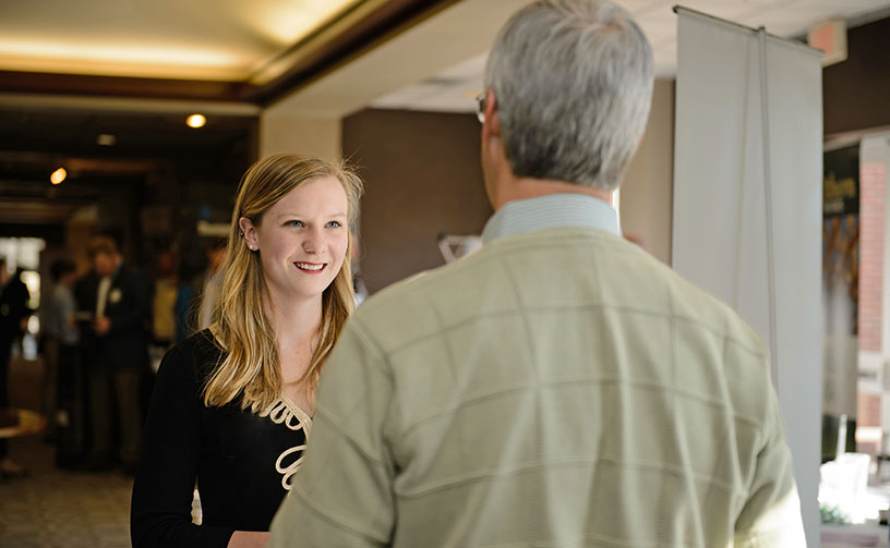 Faculty and student talking at the madren Center.