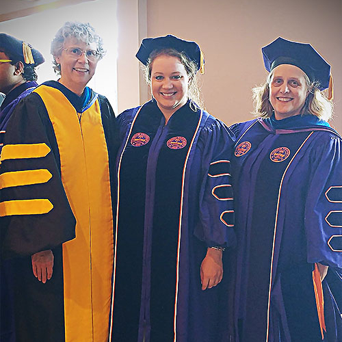 Faculty standing with graduate student