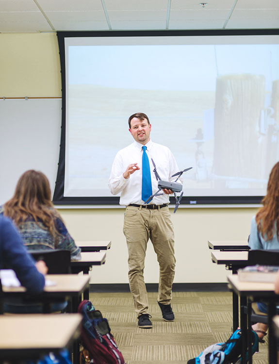 Male teacher in front of class