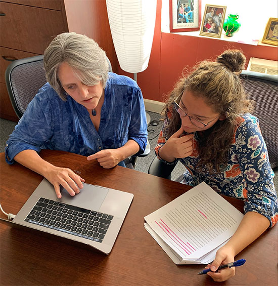 member of faculty with student, working on project