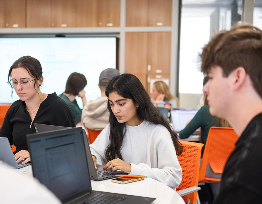 Three students in engineering class, sitting together to work.