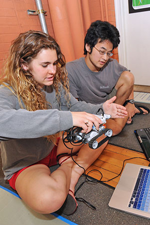 Two students working on remote car build for GE class