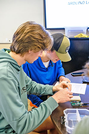 Male students building Arduino 