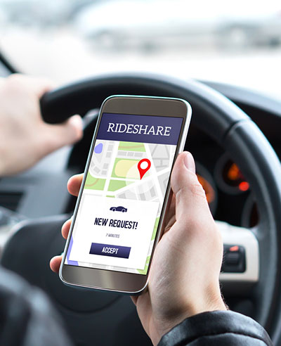 Rideshare application being used in car for alternative transportation.