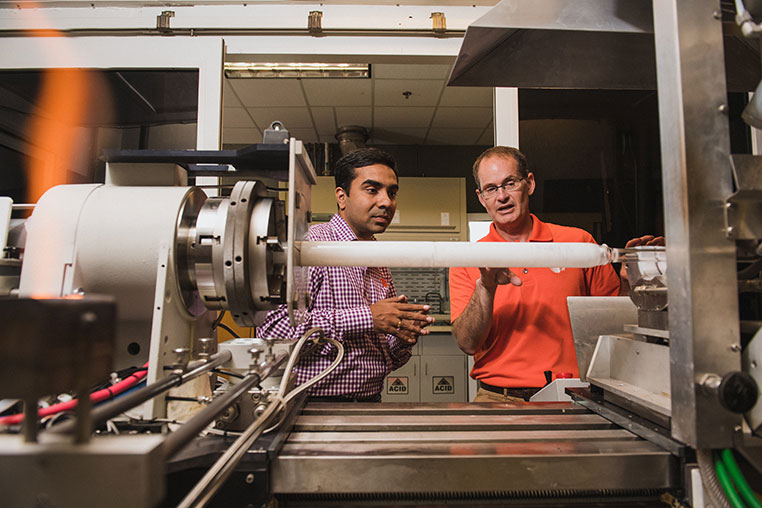 Kapil Chalil Madathil and John Ballato in lab