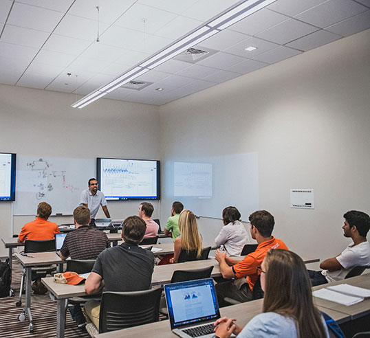 Faculty at Zucker Center in front of class.