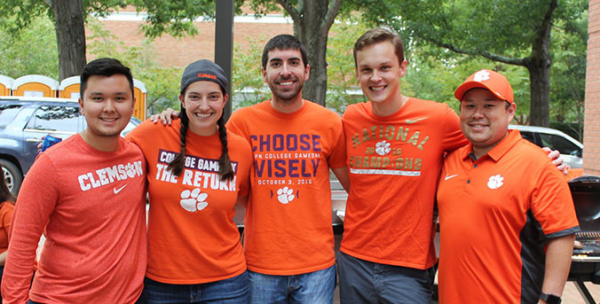 Homecoming group during football game gathering.