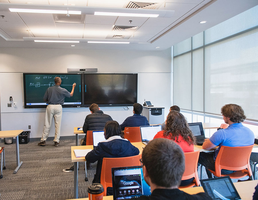 faculty member in class with several students.