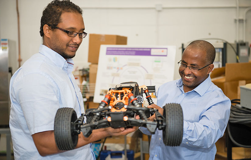 Beshah Ayalew and student with model car.