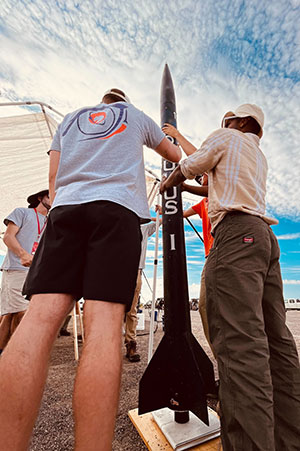 Students with rocket at competition.