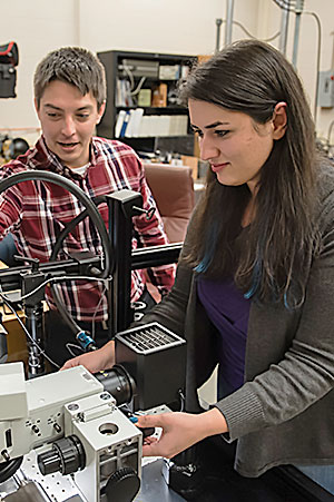 Pataky with female student in lab over equipment.