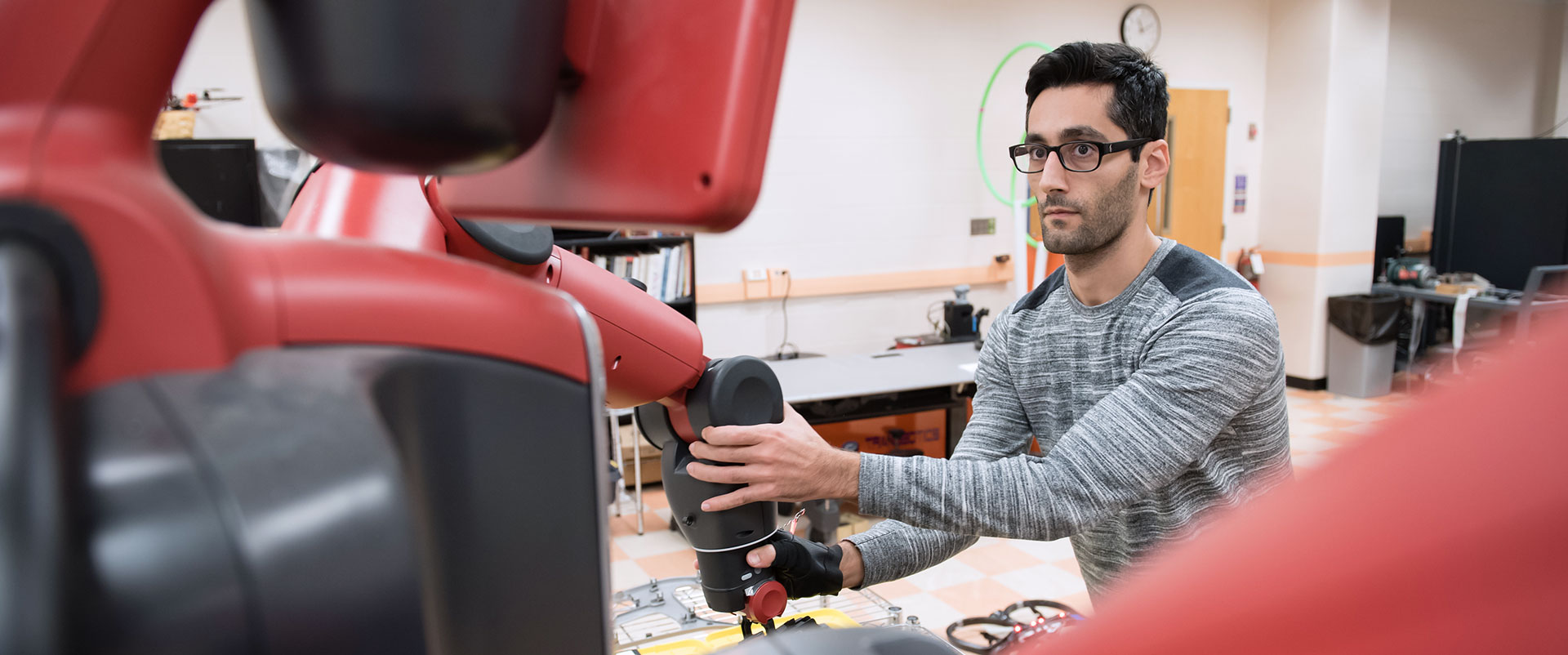 Graduate student at the Clemson composite Center discussing equipment.