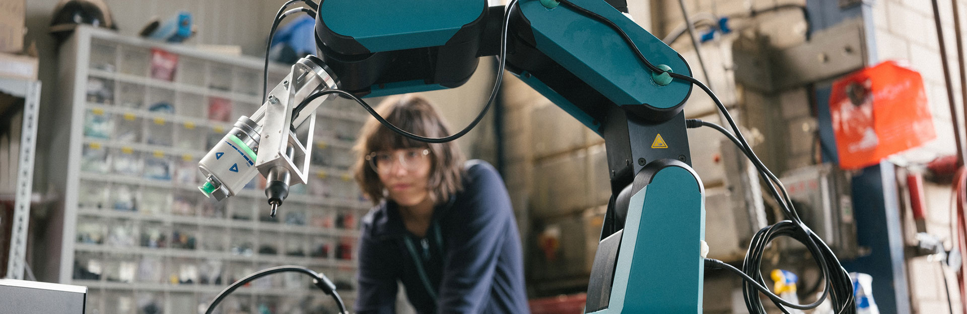 Engineer working with robotic arm.