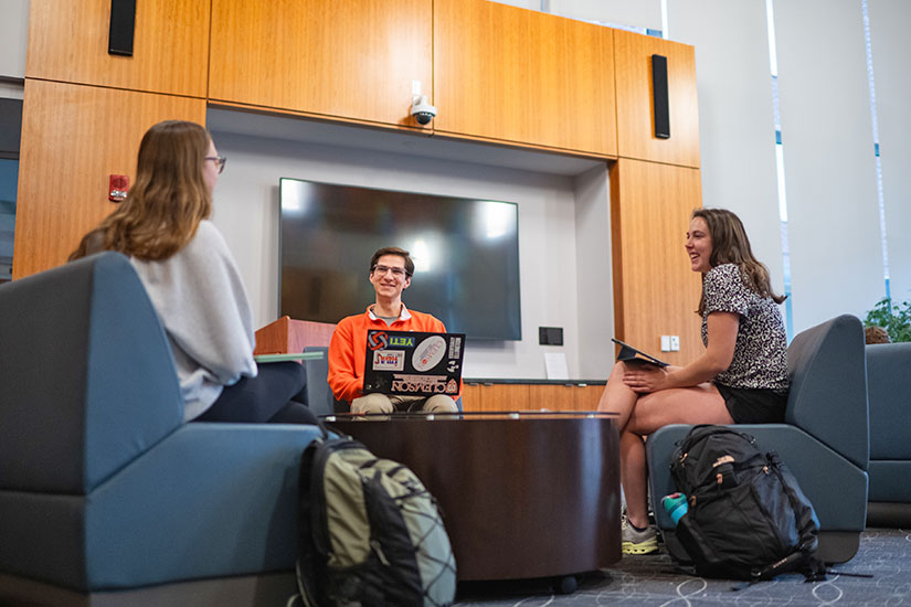 Three students talking and planning