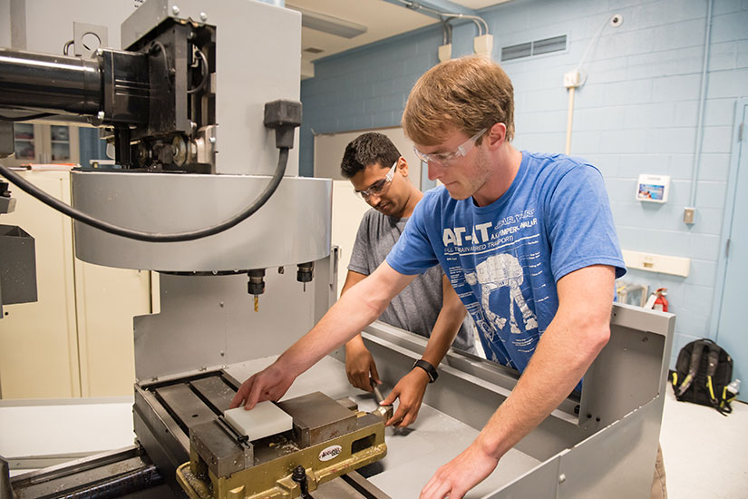 Students using equipment in the student shop on campus